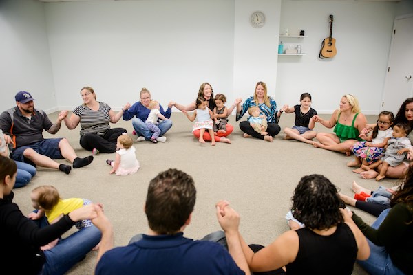 Families enjoy a Music Together class at Soulshine Arts.