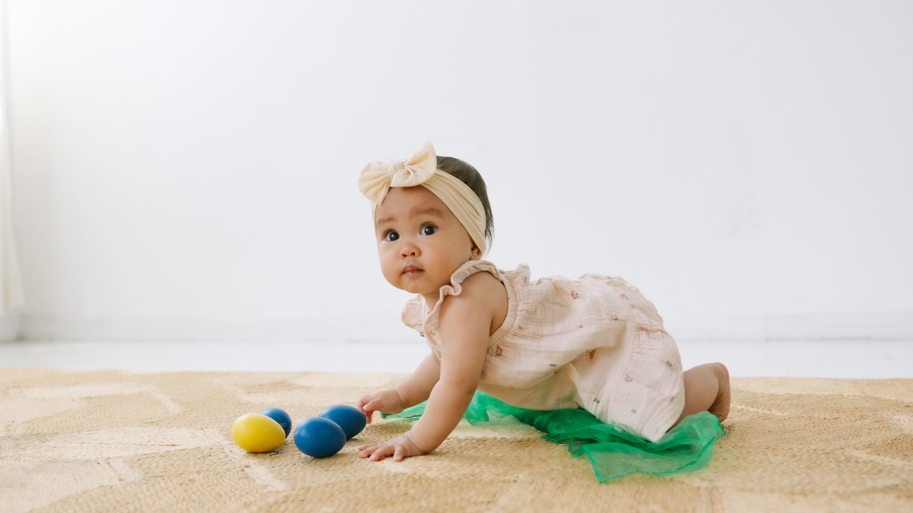 A baby exploring shakers and a scarf in an In Harmony Music Babies Only class