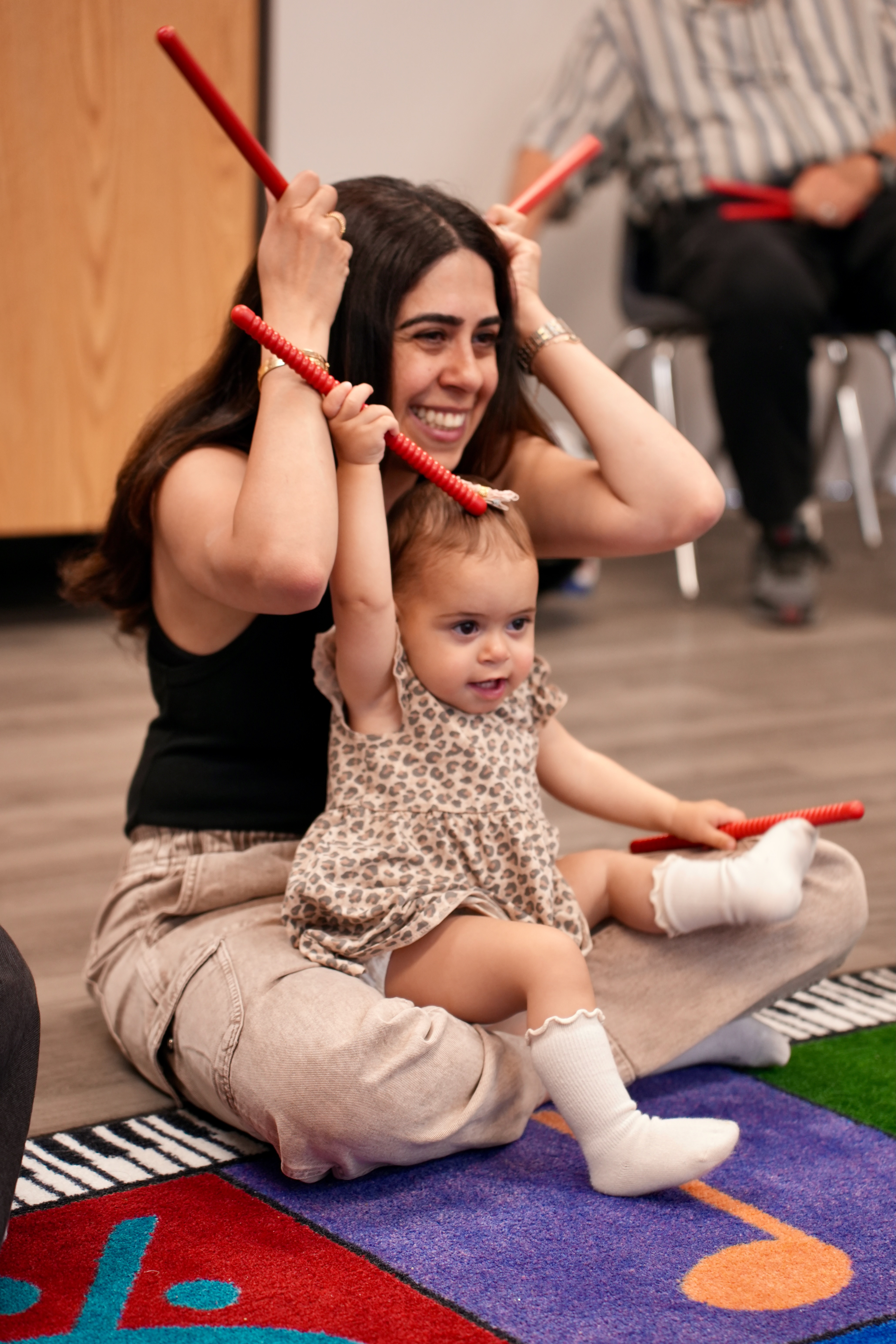 mom and child playing with sticks