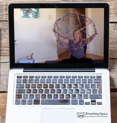 illustration of laptop with woman teaching yoga online 