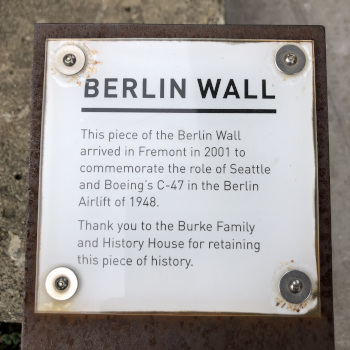 Text about the Berlin Wall: This piece of the Berlin Wall arrived in Fremont in 2011 to commemorate the role of Seattle and Boeing's C-47 in the Berlin Airlift of 1948. Thank you to the Bruke Family and History House for retaining this piece of history.